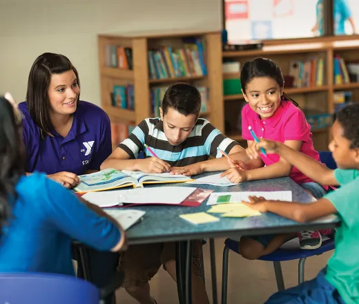 Image of Y childcare staff with elementary aged children.