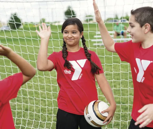 Soccer kids high fiving