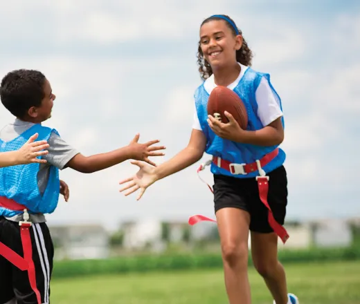 Flag Football kids high fiving