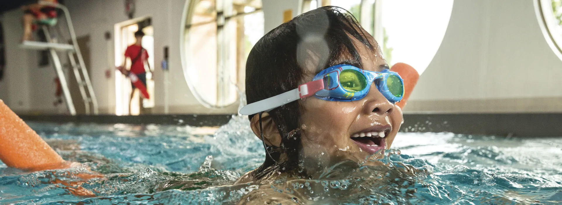 swim lessons girl with goggles in water