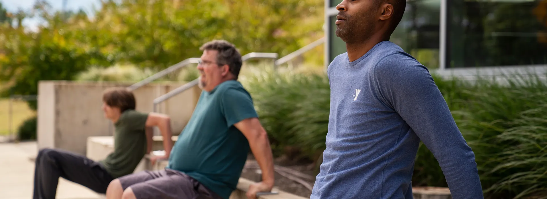 Several men doing exercise outside